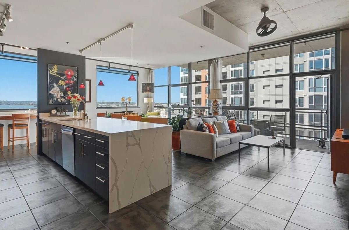 Open-plan condo kitchen and living area with bay views